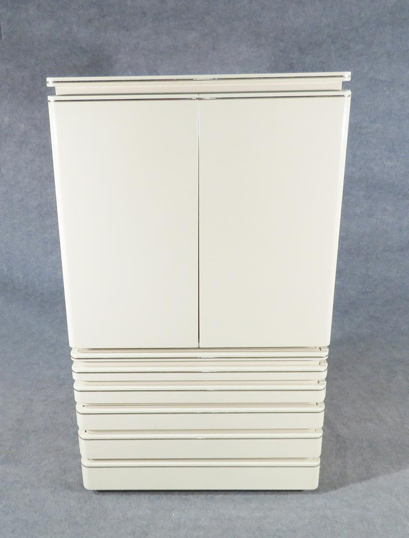 ROUGIER HIGH CHEST: Lacquer. Metal accents. Two doors containing one shelf. 3 drawers. 67 3/8" h x 40" w x 21 3/4" d.