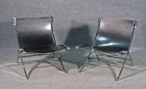 PAIR PAUL TUTTLE FOR FLEX FORM STYLE LOUNGE CHAIRS: Scissor style stainless frames. Black leather upholstery. 30" h x 26 " w x 29 3/4" d. Seat height 14".