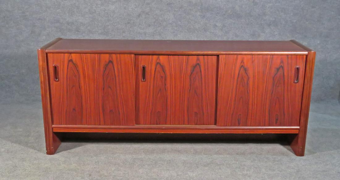 DANISH INTERFORM COLLECTION ROSEWOOD CREDENZA: Rosewood. 4 sliding doors containing one drawer on each side and one shelf. 29 1/2" h x 71" w x 18 1/2" d.