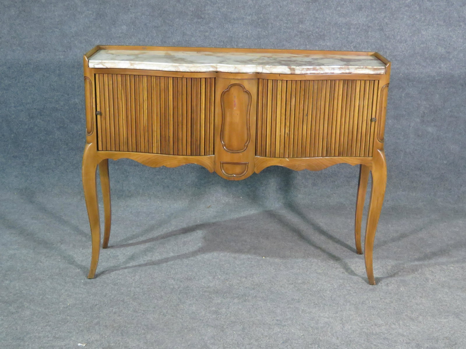 COUNTRY FRENCH MARBLE TOP TAMBOUR CONSOLE: Wood frame and gallery. Marble top. 2 tambour sliding doors. Metal hardware. 30 7/8" h X 39 1/4" w x 12 1/2" d.