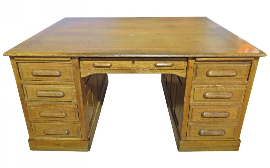 OAK PARTNERS DESK: Oak. 8 dovetailed drawers on both sides. 2 pull out trays. 29 3/4" h x 60 1/8" w x 48 1/4" d.