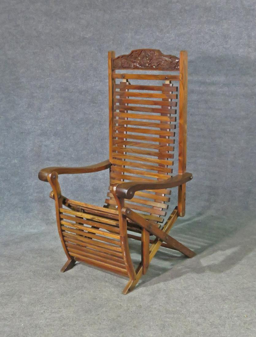 ANTIQUE CARVED ROSEWOOD RECLINER: Carved birds and flowers. Rosewood. 47 1/2" h x 23 3/4" w x 27 1/2" d (extended) x 63".