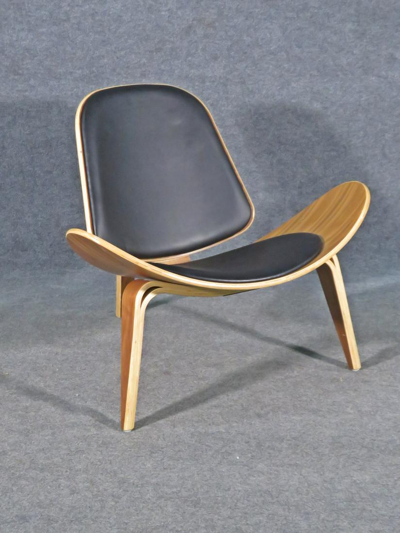 HANS WEGNER STYLE WALNUT LOUNGE CHAIR: Walnut frame. Faux leather upholstery. 30 1/4" h x 35 1/2" w x 29 1/2" d. Seat height 16".