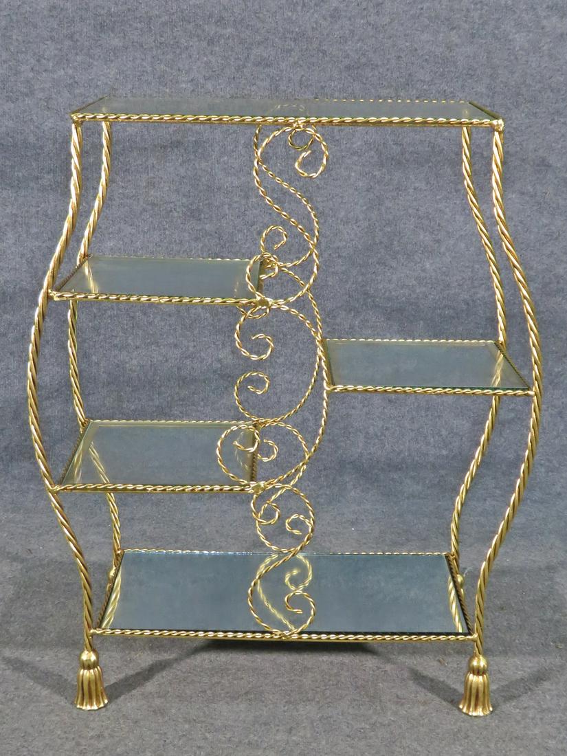 GILDED ROPE TWIST ETAGERE: Gilded rope twist frame. 4 glass shelves. 1 mirrored shelf. 37" h x 30 1/4" w x 12" d.