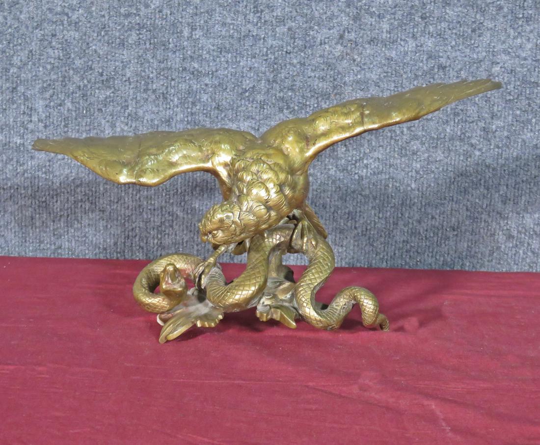 BRONZE EAGLE WITH SNAKE: Bronze. Figural. 6 1/4" h x 13 1/2" w x 6" d.