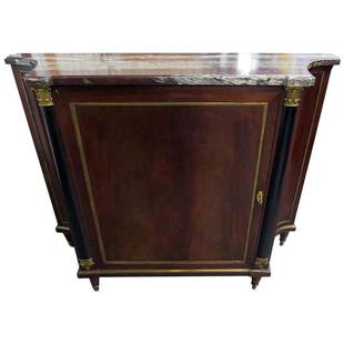 FLAME MAHOGANY MARBLE TOP COMMODE ATTR MAISON FOREST: Flame mahogany. Marble top. Bronze mounted. One door containing 2 shelves, bronze mounts and ebonized accents. 40 1/2" h x 52" w x 17" d.