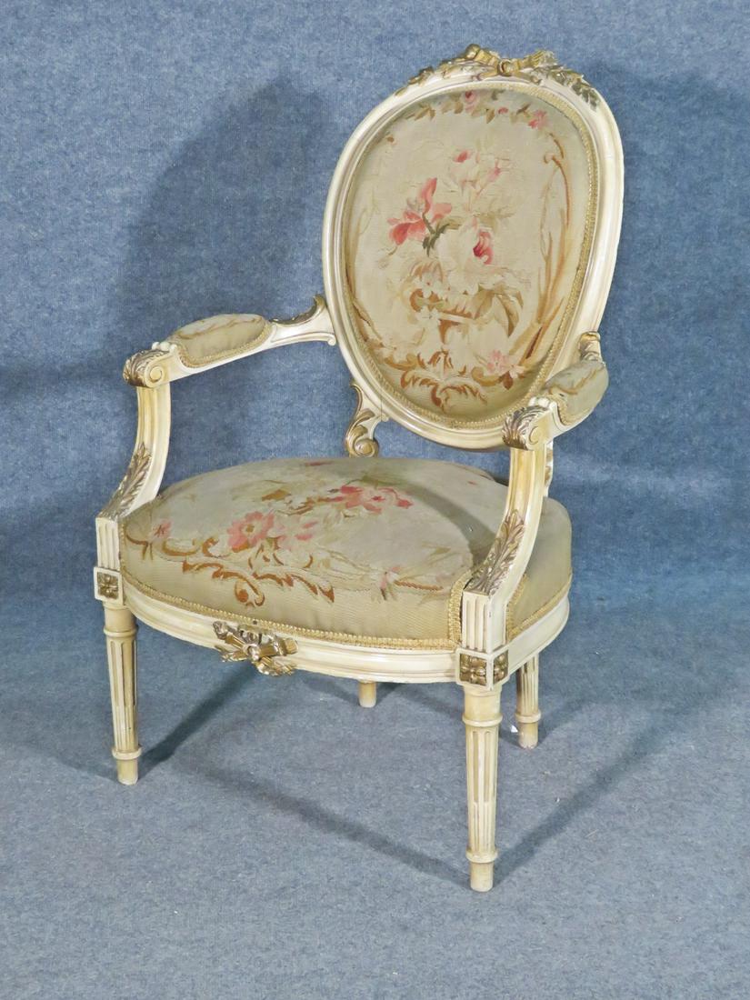 LOUIS XV STYLE NEEDLEPOINT FAUTEUIL: Carved wood frame. Gilded accents. Needlepoint back, seat and arm rests.