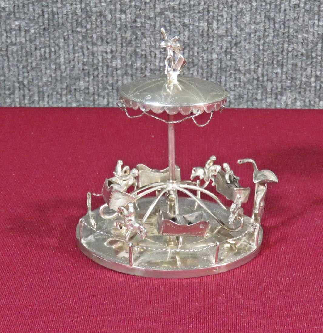 STERLING CAROUSEL: Sterling. SBL makers mark. Hallmarked. 5" h x 4 1/2" w x 3 1/2" d. Approximate 5.59 troy ounces.