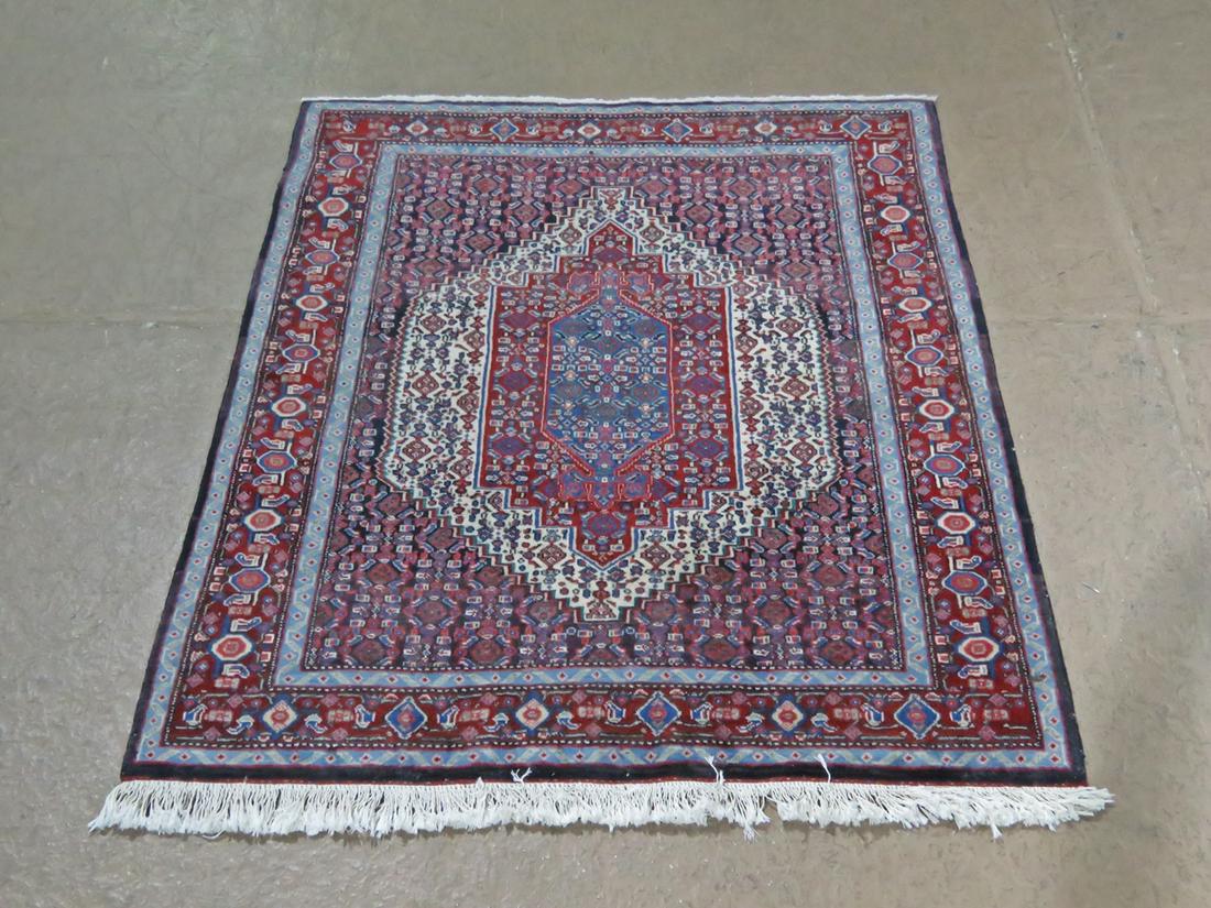 ORIENTAL RUG: Multi colored. Fringe on ends. 58 3/4" l x 43 1/4" w.
