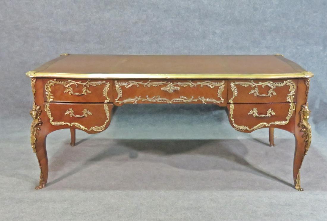 LOUIS XV STYLE LEATHER TOP BUREAU PLAT: Brass figural accents. Dovetail drawers. 5 drawers. 30 3/8" h x 69 3/4" w x 35 1/4" d.
