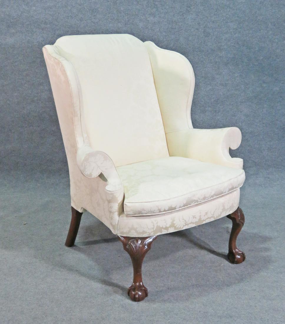 KINDEL WINTERTHUR CLUB FOOT WINGBACK CHAIR: Floral upholstery. Carved club feet. 44 1/2" h x 38 1/2" w x 34 1/2" d. Seat height 20 1/2".