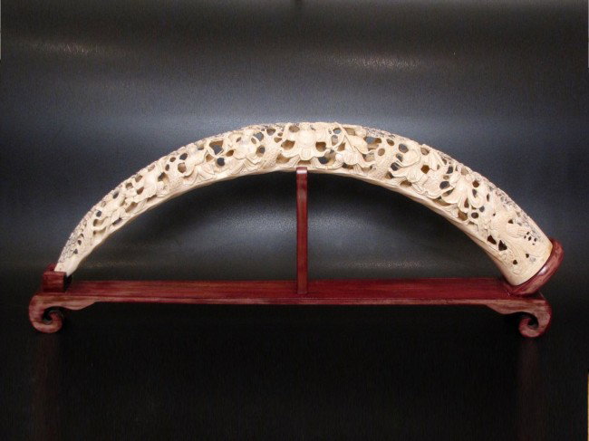 25" CARVED IVORY TUSK w/ FIGURES: Mid 20th c. Very good condition. Includes stand.