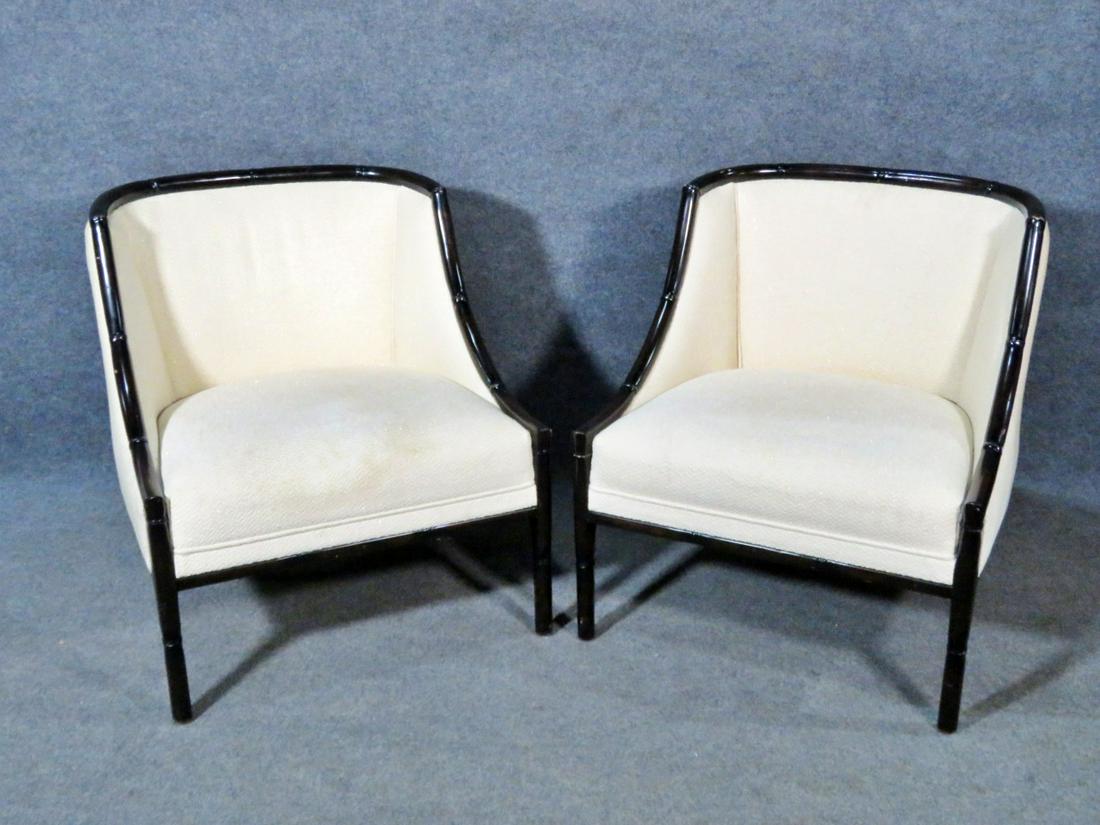 PAIR FAUX BAMBOO CLUB CHAIRS: White upholstery. Faux bamboo frame. 2 accent pillows. 31 1/4" h x 27 1/4" w x 26" d. Seat height 17".
