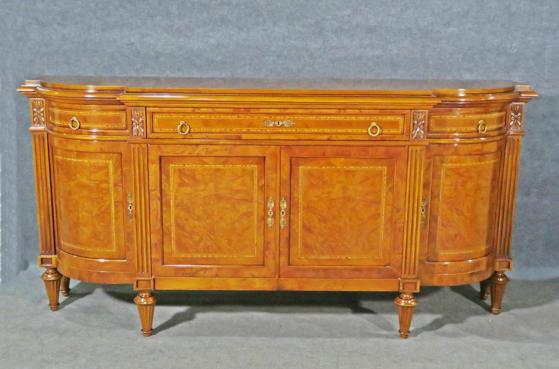 RHO MOBILI D'EPOCA SIDEBOARD: Italian. Burl. 3 drawers. Brass hardware. 1 door on each side containing 1 shelf. 2 doors in middle containing 1 shelf. Inlaid. 41 3/4" h x 85 3/8" w x 22 1/8"d.