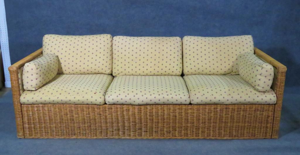 RATTAN BOHO SOFA: Rattan. Upholstered back and inside arms. Removable upholstered seat cushions and accents pillows. 25 1/4" h x 85 3/4" w x 35" d. Seat height 16".