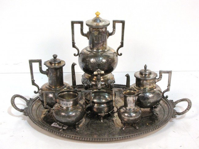 6 pc. VICTORIAN SILVERPLATE TEA SET w/ TRAY: Wilcox silverplate. Classical masks and hoof feet. Good condition. Sugar bowl missing lid. Coffee pot 16". Tray 30 1/2" 19 3/4. From the estate of former Ambassador to Argentina James Bruce.
