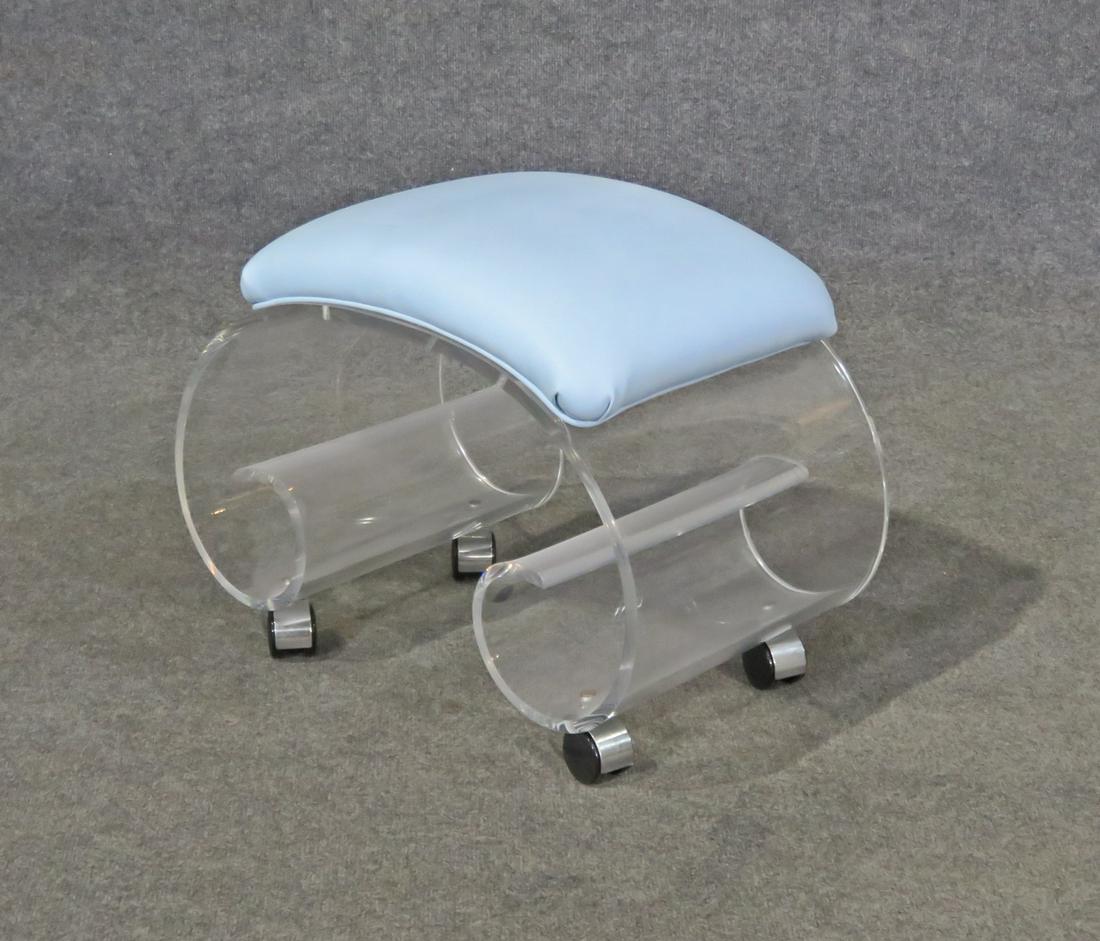 LUCITE BENCH: Lucite base. On casters. Leather upholstery. 17 1/2" h x 22 1/2" w x 13 7/8" d.