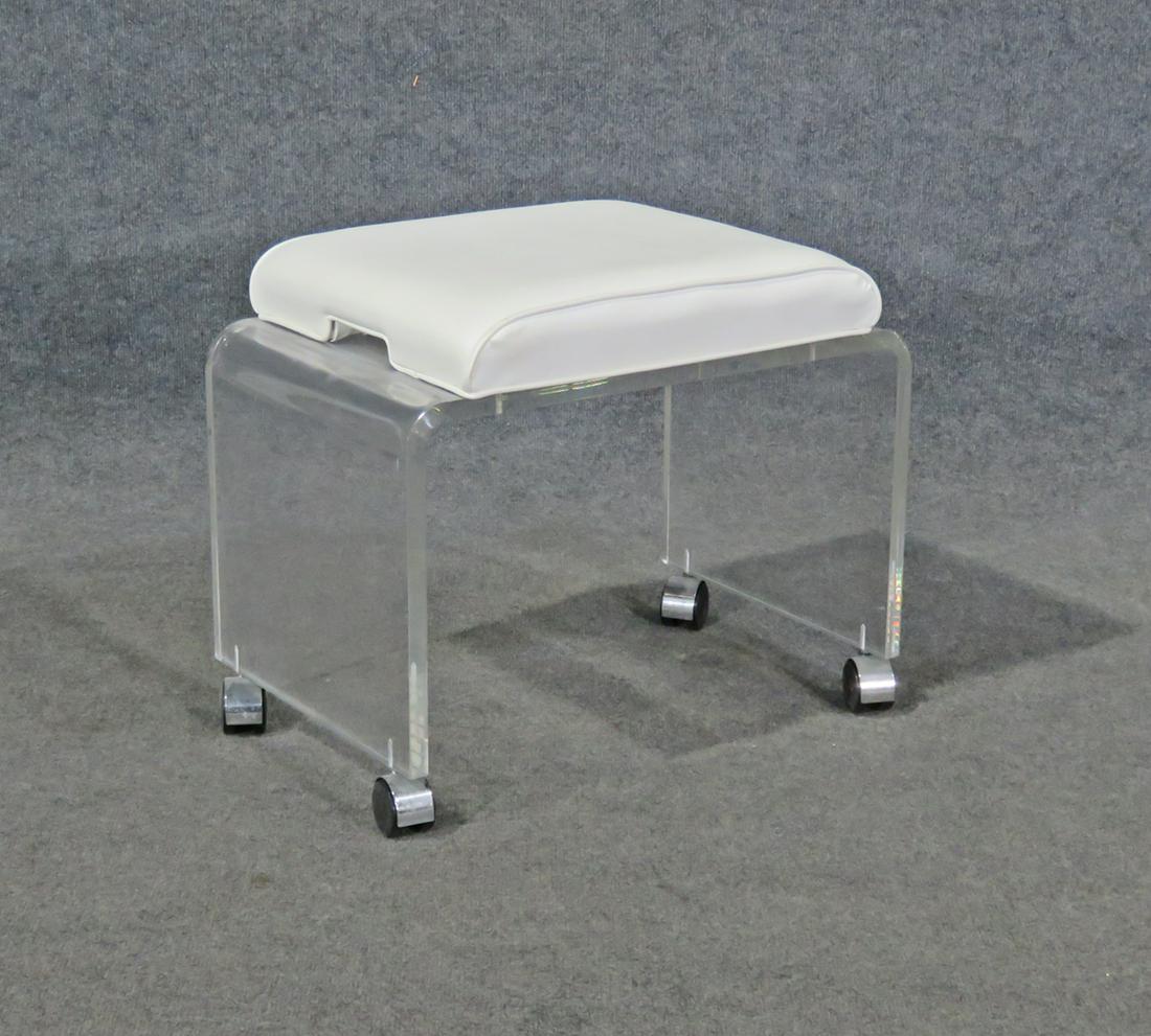 LUCITE BENCH: Lucite base. On casters. 18 1/2" h x 21 1/4" w x 14 1/8" d.