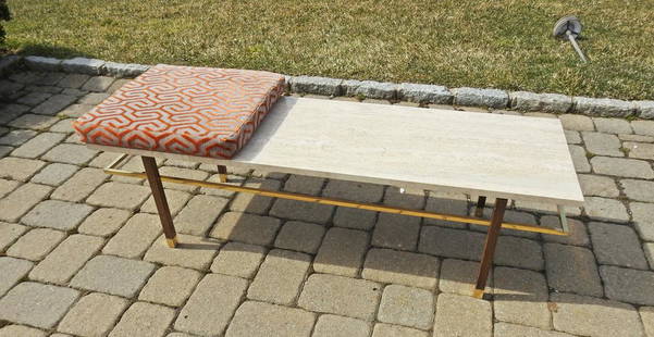 HARVEY PROBBER COFFEE TABLE: Travertine top. Brass accents. Mahogany. Circa 1960's. 15" h x 54" w x 18" d. Cushion 20" square x 2 1/2" d.