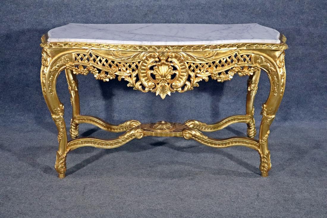 FRENCH MARBLE TOP CENTER TABLE: Carved gilt frame and legs. Floral detail. Marble top. 32 3/4" h x 57 1/4" w x 30 5/8" d.