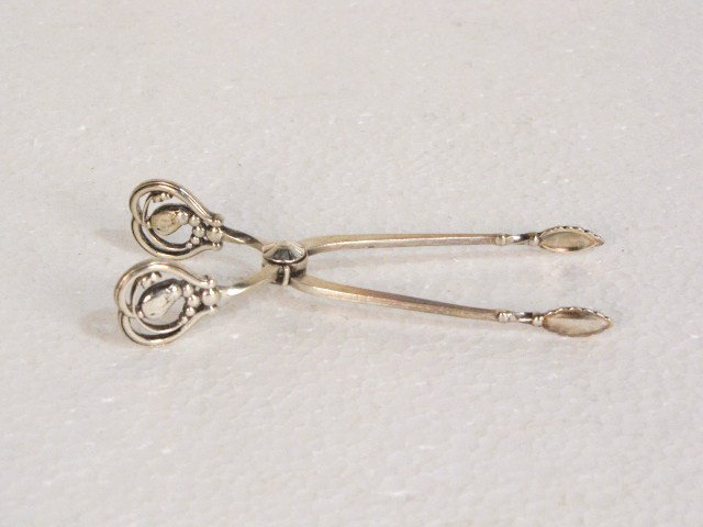GEORG JENSEN BLOSSOM STERLING SUGAR TONGS: Very good condition.