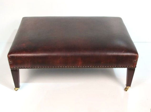 GEORGE SMITH ENGLISH LEATHER OTTOMAN: Mahogany. Brass casters. Some marks on leather. Very good condition. 17"h. x 41"w. x 30"d.