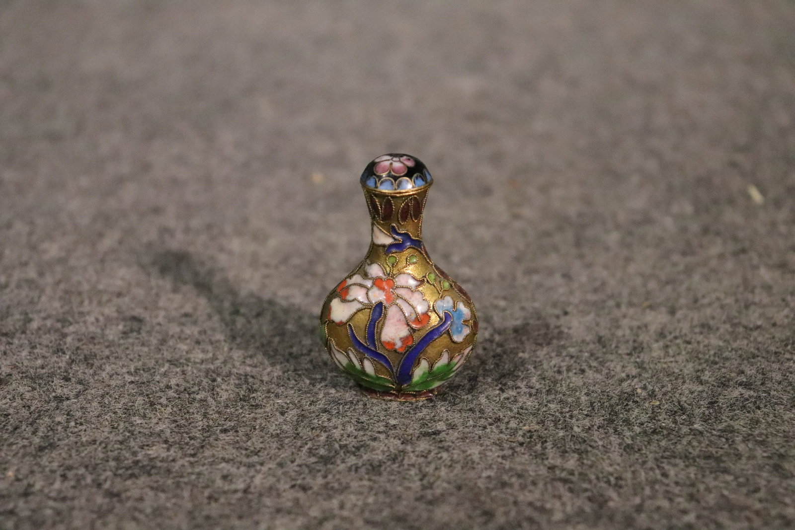 ASIAN SNUFF BOTTLE: Metal with floral details. Measures 2 1 2/" h x 1 3/8" w x 7/8" d.