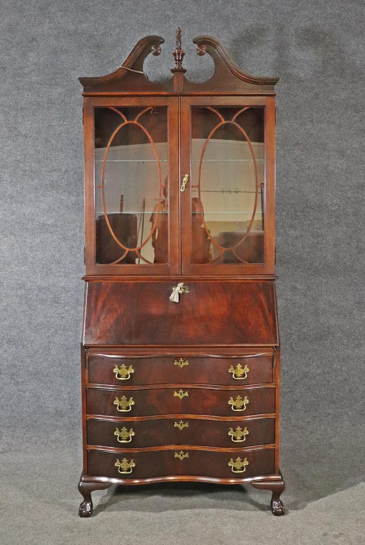 JASPER CABINET MAHOGANY SECRETARY DESK: Mahogany. Claw foot. Metal hardware. Lighted. Two glass doors containing 2 glass shelves. Pull down door containing fitted interior. 4 drawers. 82" h x 33 1/2" w x 16" d.