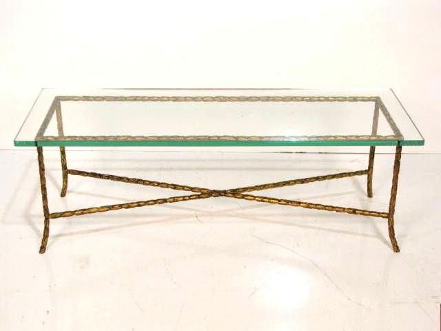 BAGUES STYLE GILT METAL COFFEE TABLE: 3 1/4" thick glass top. Very good condition. 15 1/4"h. x 44"w. x 14 1/4"d.