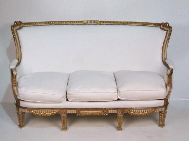 MAISON JANSEN PAINTED & GILT CARVED SOFA: Finely carved frame. Cream painted & gilt. 24 1/2"h. x 70 1/2"w. x 33 1/4"d.
