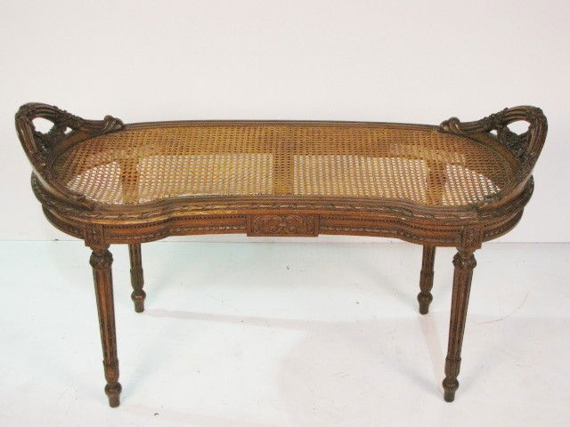 FRENCH CARVED & CANED BENCH: Walnut. Finely carved. Some damage to cane. 24 1/2"h. x 42 1/2"w. x 19"d.