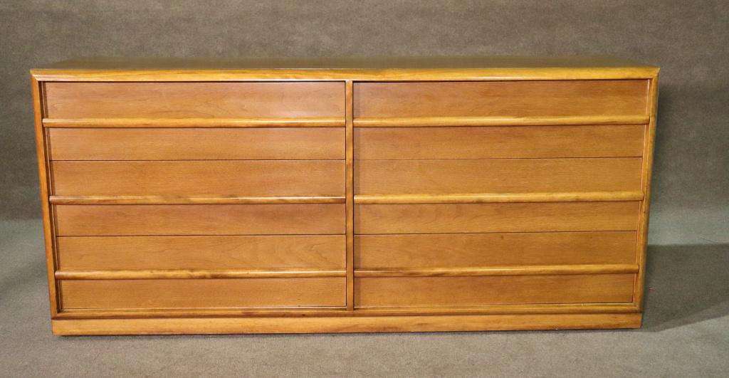 TH ROBSJOHN GIBBINGS FOR WIDDICOMB LONG DRESSER: Wood. 6 dovetailed drawers. On casters. 31 1/4" h x 68 3/8" w x 20 1/2" d.