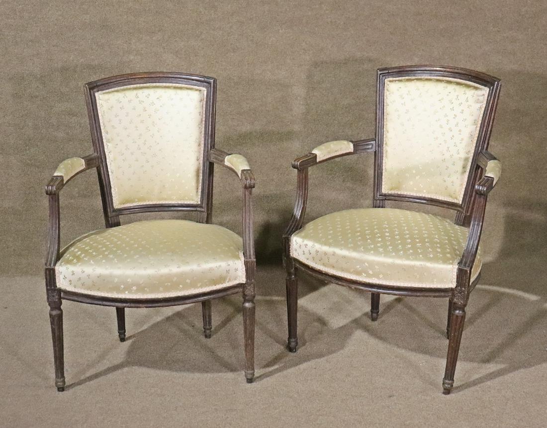 PAIR LOUIS XVI STYLE FAUTEUILS: Carved wood frames. Upholstered back, seat and arms. 33 1/8" h x 21 1/2" w x 23 1/4" d. Seat height 16 1/2".