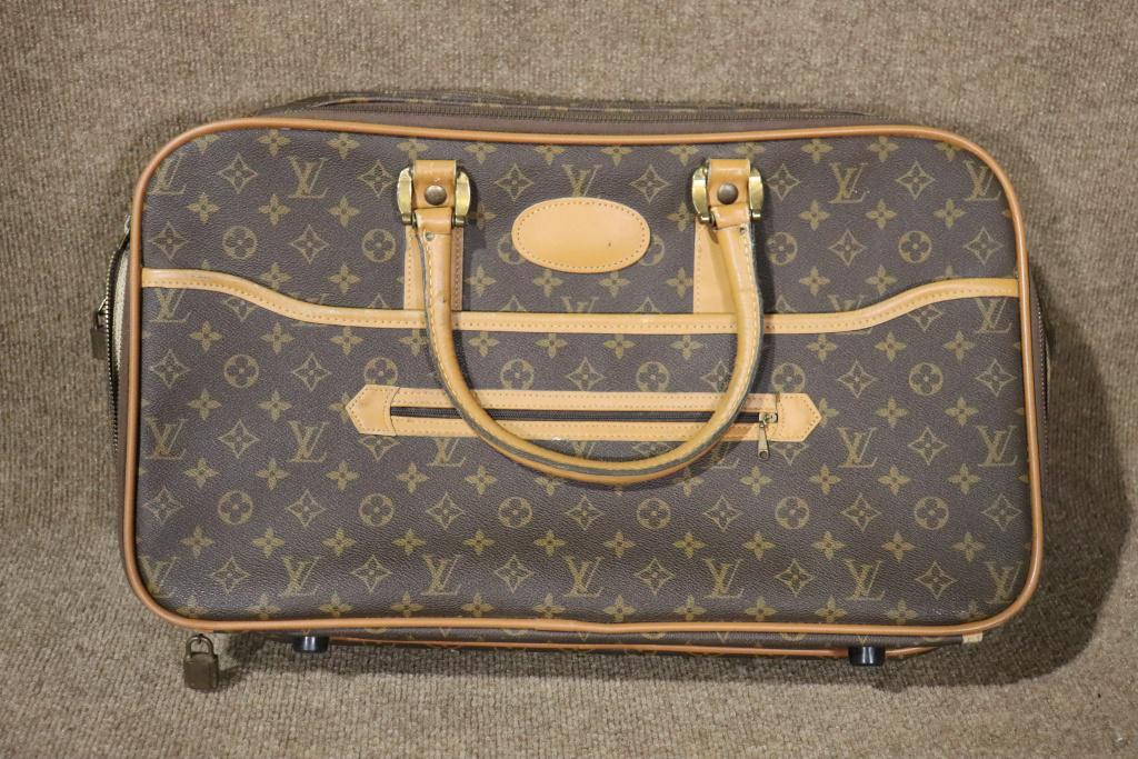 LOUIS VUITTON TRAVEL BAG: Fabric. Leather. Saks Fifth Avenue. 13" h x 21" w x 7" d.