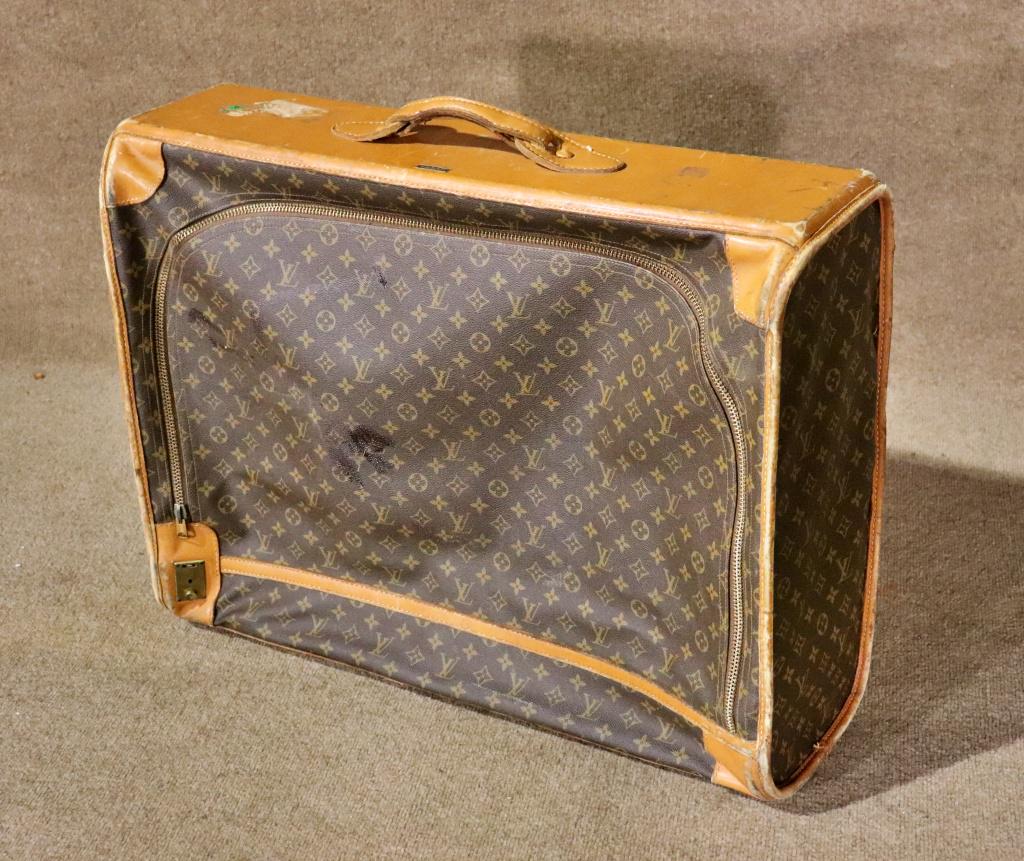LOUIS VUITTON SUITCASE: Fabric. Leather. Louis Vuitton. Paris France. Manufactured by The French Co., USA under special license. 22" h x 28" w x 9" d.