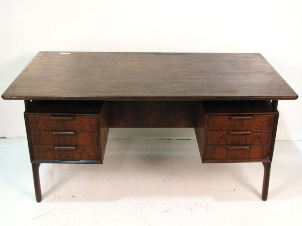 GUNNI OMANN for OMANN JUN ROSEWOOD DESK: very good condition with light wear to top. 28 3/4"h. x 60 1/2"w. x 31 3/4"d.