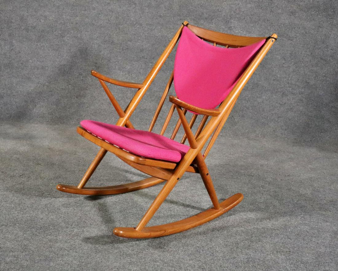 BRAMIN DANISH TEAK ROCKER: Danish. Teak. Upholstered cushions. Strap seat. Spindle back. 32 5/8" h x 25 7/8" w x 30 1/8" d. Seat height w/out cushion 16 1/2".