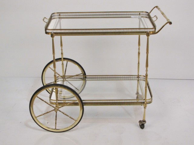 BRASS TEA CART: Glass inserts. Very good condition. 27 1/4"h. x 29 1/4"w. x 17 1/4"d.