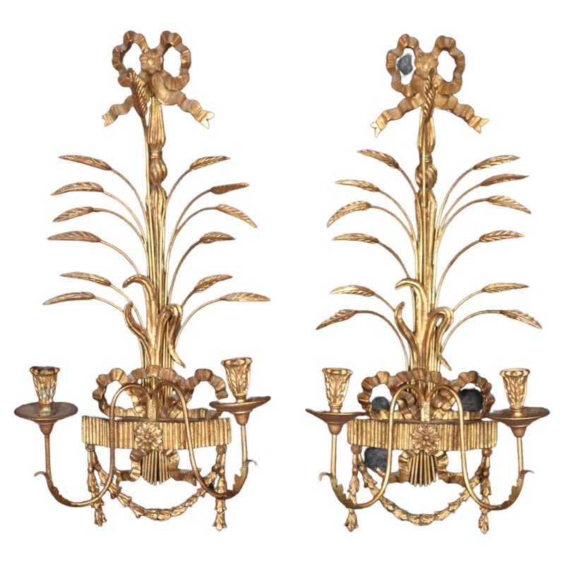 PAIR ITALIAN SHEAF OF WHEAT & BOW GILT SCONCES: Labeled Palladio. Circa 1950. Non- electrified. Wheat sheaf and bowtie ornamentation in gold leaf. 28" h x 13 1/2" w x 6 1/2" d.