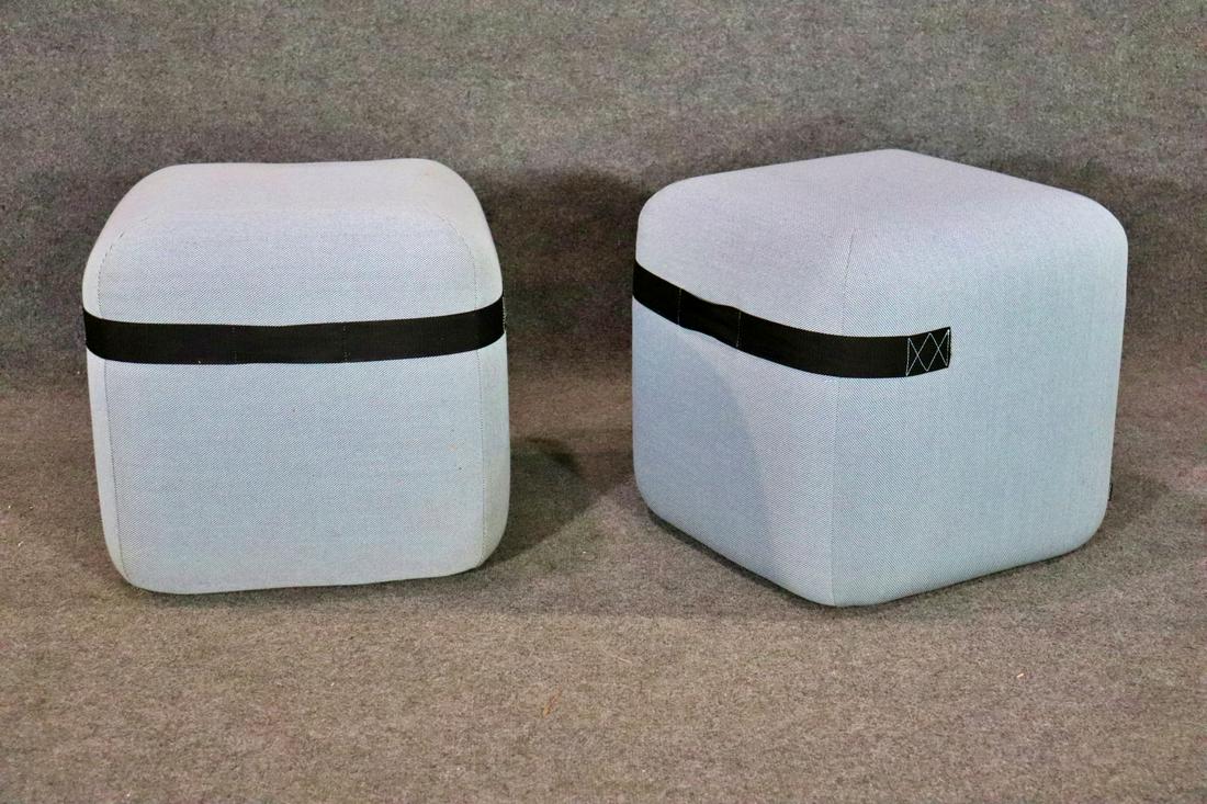 PAIR PIERO LISSONI OTTOMANS: Blue upholstered. Black strap accent. On castors. 19" h x 20 1/2" w x 20 1/2" d.