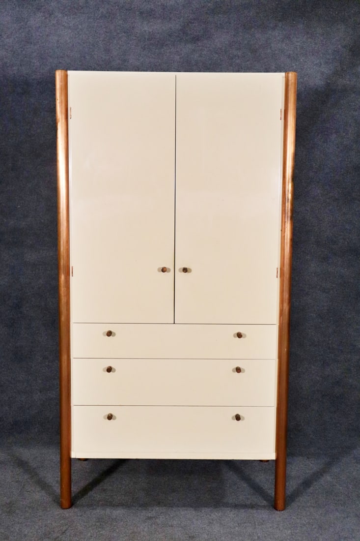 ROUGIER CHIFFONIER: Copper finish metal legs and hardware. Laminate. 2 doors on top containing 2 shelves each. 3 drawers. 68 1/4" h x 35 1/2" w x 22 1/4" d.