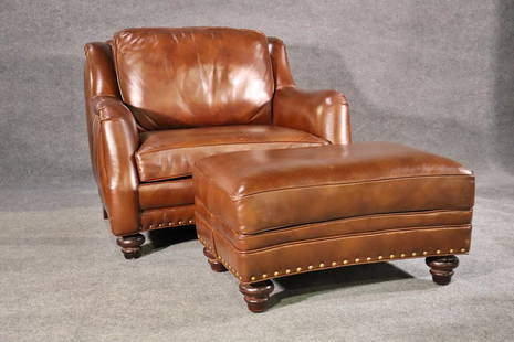 HANCOCK & MOORE OVERSIZED CLUB CHAIR & OTTOMAN "SUNDANCE": Leather upholstery. Nail head trim. Wood legs. Chair measures 37 1/2" h x 44 1/2" w x 42 1/2" d. Seat height 30". Ottoman measures 18 1/2" h x 35" w x 25" d.