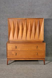 ALBERT PARVIN FOR AMERICAN OF MARTINSVILLE DIAMOND FRONT HIGH CHEST: Walnut. Diamond front. 2 dovetailed doors containing 3 drawers. 2 dovetailed drawers on bottom. 50 5/8" h x 41 1/2" w x 19 5/8" d.