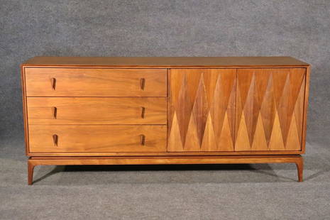 ALBERT PARVIN FOR AMERICAN OF MARTINSVILLE DIAMOND FRONT DRESSER: Walnut. Diamond front. 3 dovetailed drawers. 2 doors containing 3 dovetailed drawers. 32 1/8" h x 73 1/2" w x 19 1/2" d.