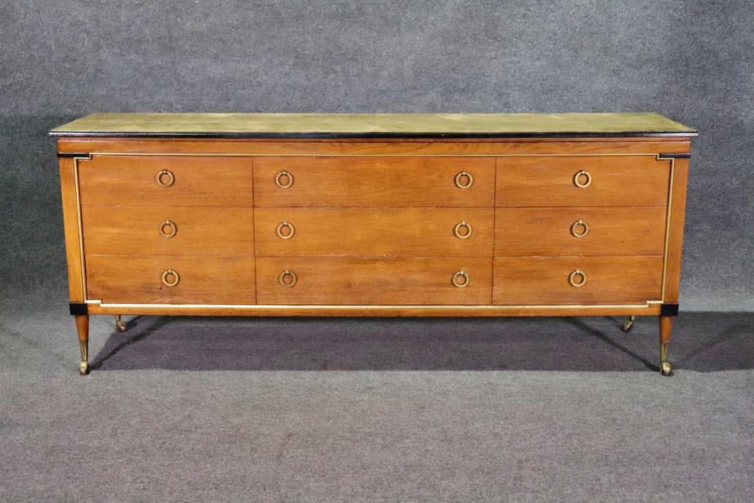 KENT MODERN TRIPLE DRESSER: Wood. On casters. Brass hardware and accents. Ebonized accents. 32" h x 72 7/8" w x 19 1/2" d.