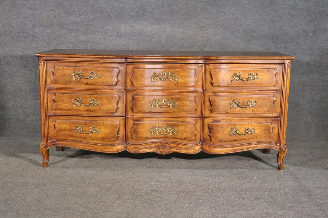 HENREDON COUNTRY FRENCH TRIPLE DRESSER: Henredon. Carved wood. 9 drawers. 33 1/2" h x 72" w x 20 3/4" d.