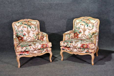 PAIR REGENCY FLORAL FABRIC SCULPTED WINGBACK CHAIRS: Carved distressed wood frames. Floral upholstery. 36 1/2" h x 29 1/2" w x 30 1/2" d. Seat height 18".