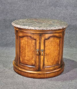 HERNREDON MARBLE TOP DRUM TABLE: Walnut. Marble top. 2 doors containing 1 shelf. Brass hardware. 28 1/4" h x 32 1/8" w x 32 1/8" d.