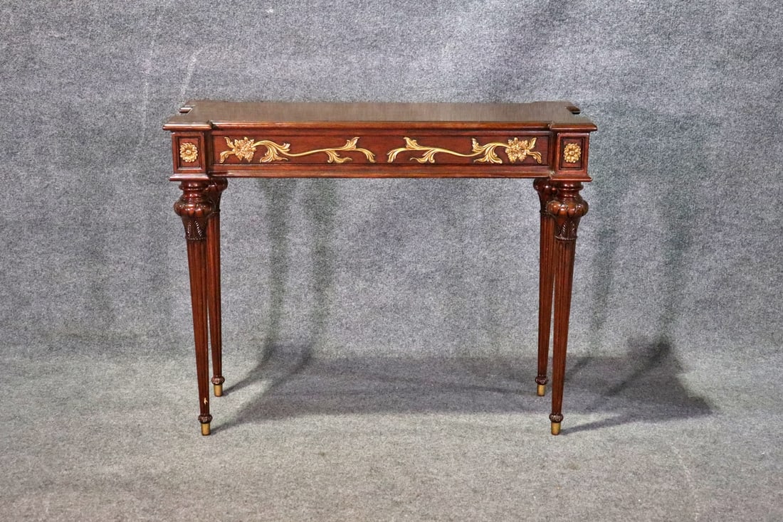 LOUIS XVI STYLE MAHOGANY CONSOLE: Mahogany. Gilt accents. Brass foot caps. 33 3/4" h x 42" w x 15" d.