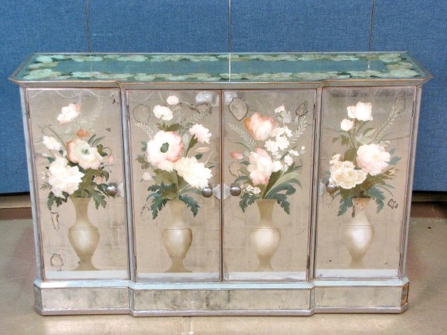 ITALIAN EGLOMISE MIRRORED CREDENZA: Very good condition. Small crack on one door. One tiny mirror tile missing. 34 1/2"h. x 53 1/2"w. x 15 1/2"d. Part of a collection of mirrored furniture from a Long Island estate.